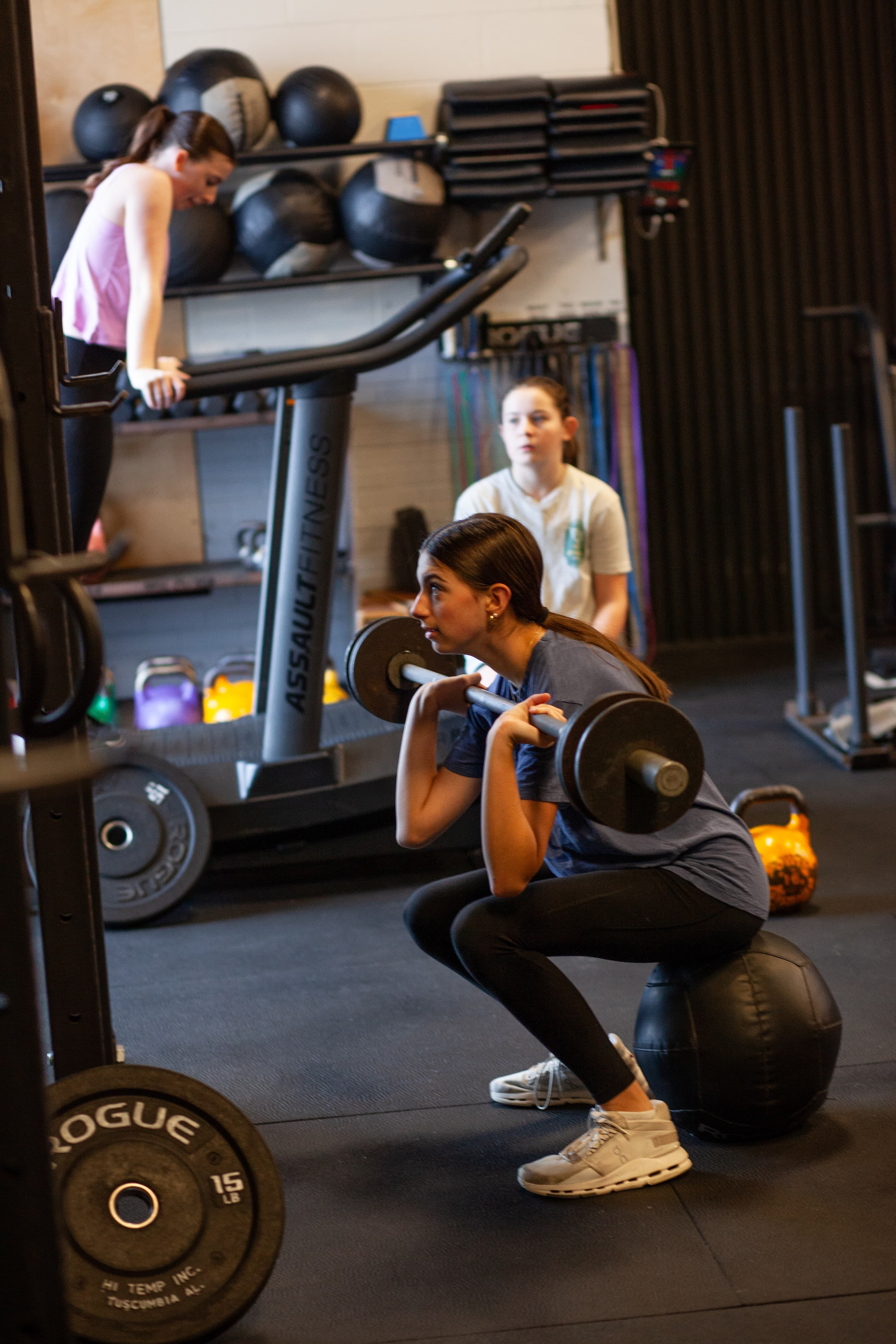 Members using gym equipment independently