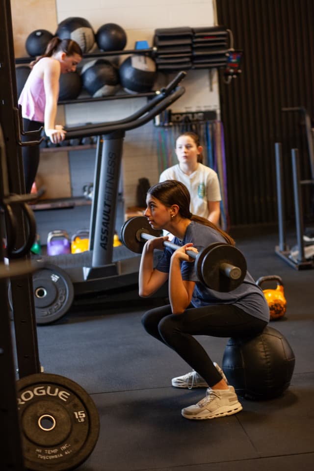 Members using gym equipment independently
